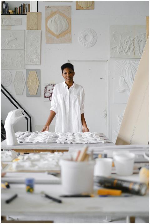 Portrait of an artist working with ceramics in a b