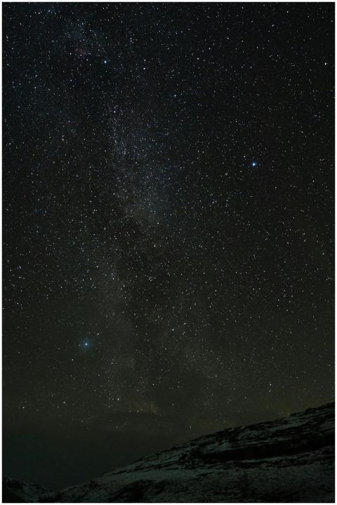 Clear starry sky over Norwegian landscape with vis