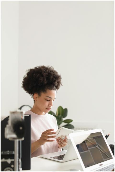 Young woman using a laptop and smartphone in a mod