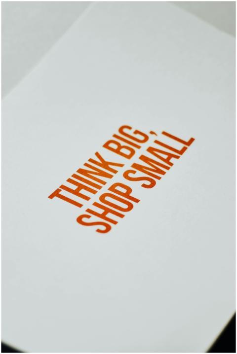 Close-up of paper sign with 'Think Big, Shop Small