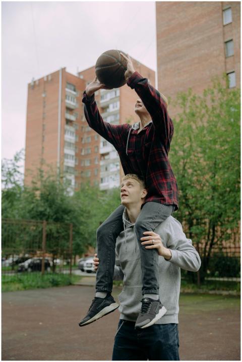 Two brothers enjoying a playful basketball game ou