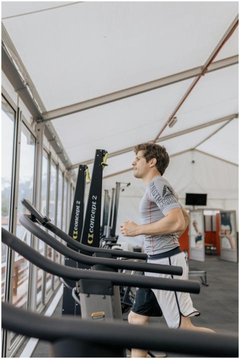 Man exercising on treadmill in a modern indoor gym