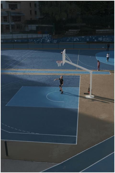 Aerial shot of children playing basketball on a co