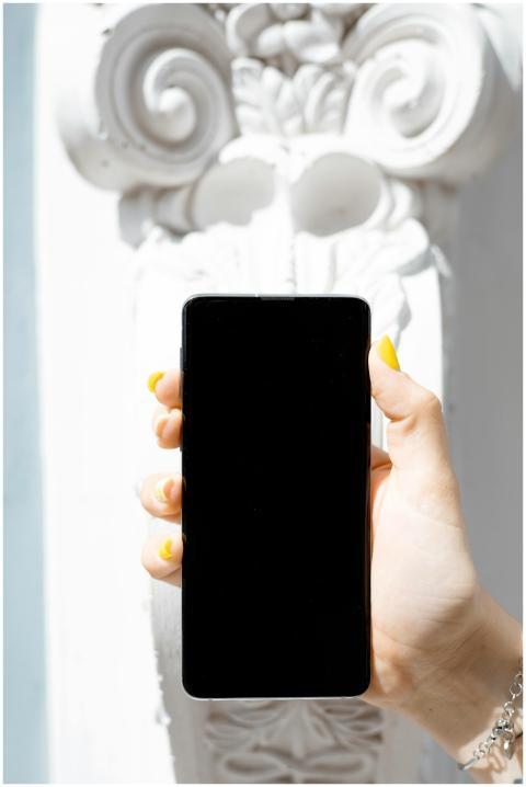 A close-up of a smartphone held by a hand against