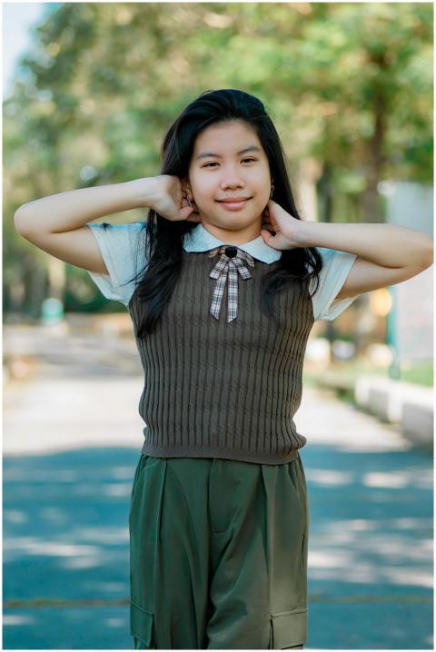 Portrait of a young girl posing confidently outdoo