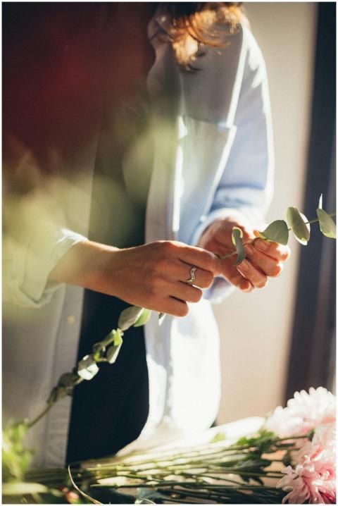 A florist carefully arranges flowers, capturing th