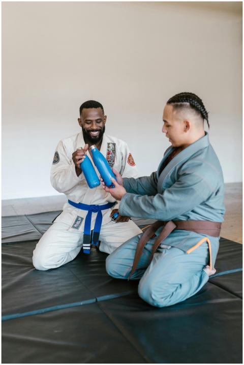 Martial artists in a dojo sharing sports bottles w