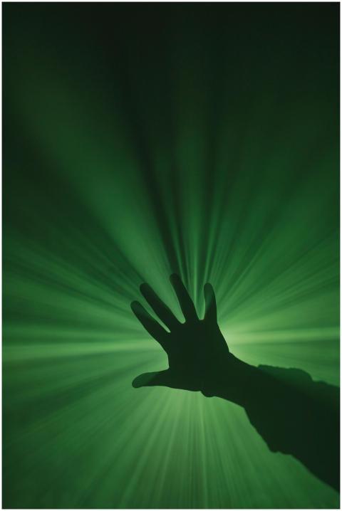 A mysterious silhouette of a hand reaching toward