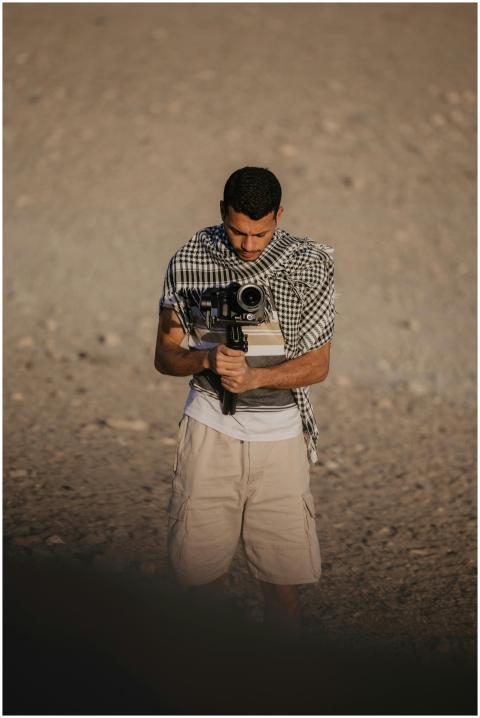A man with a camera capturing the serene desert se