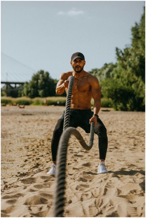 Fitness enthusiast performing intense battle rope