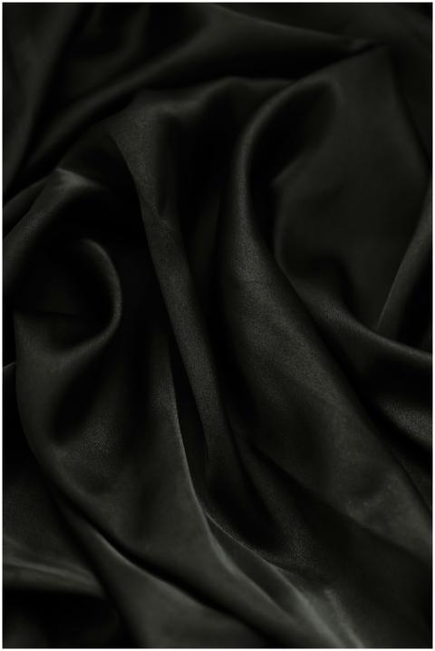 Close-up of smooth rippled black fabric, perfect f