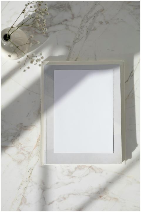 Elegant vertical mockup of a wooden frame on a mar