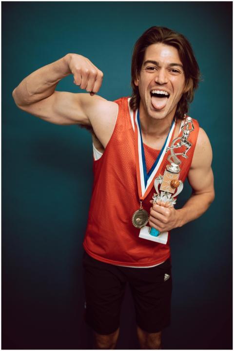 Animated young male athlete in red jersey celebrat