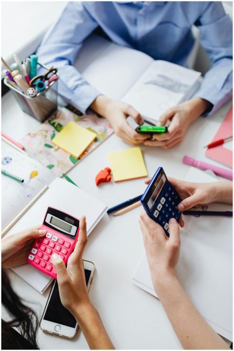 Group of children using calculators for math homew