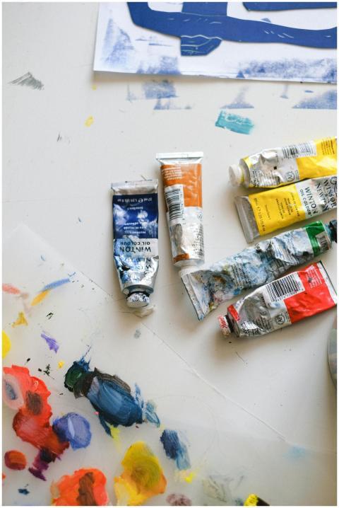 Top view of a creative art workspace with paint tu