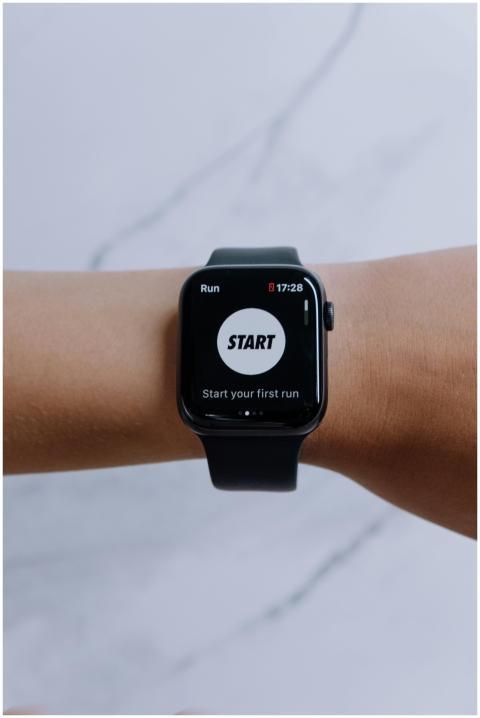 Close-up of a smartwatch showing a running app on