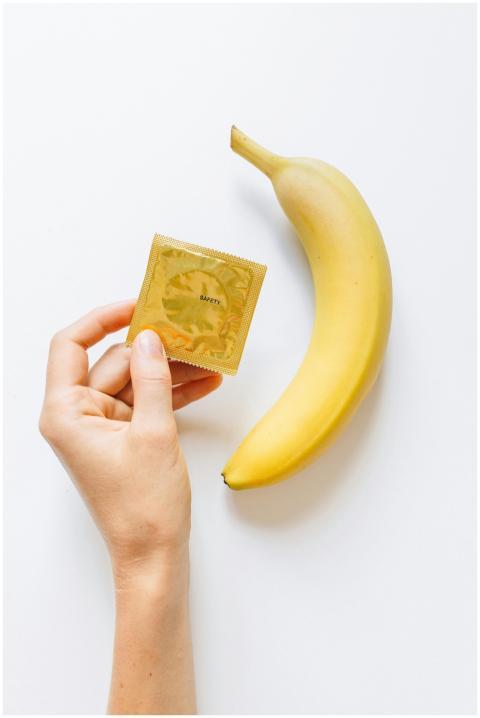 Conceptual image featuring a banana and a condom t