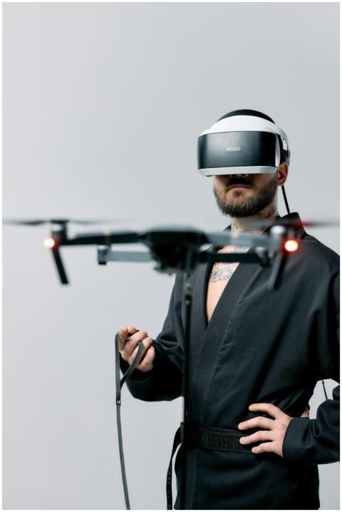 Man controlling a drone with virtual reality heads