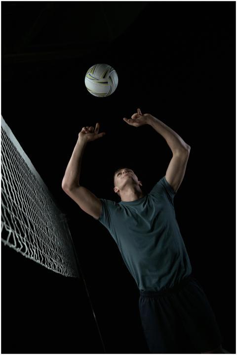 Athlete in action, leaping for a volleyball spike