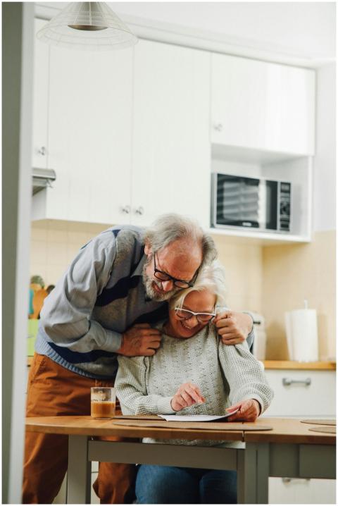 Elderly couple enjoying a tender moment in their c