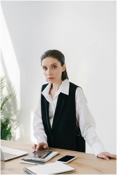 Businesswoman in a white shirt and vest working on