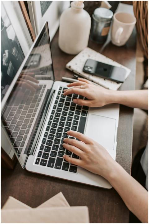 From above of unrecognizable woman sitting at tabl