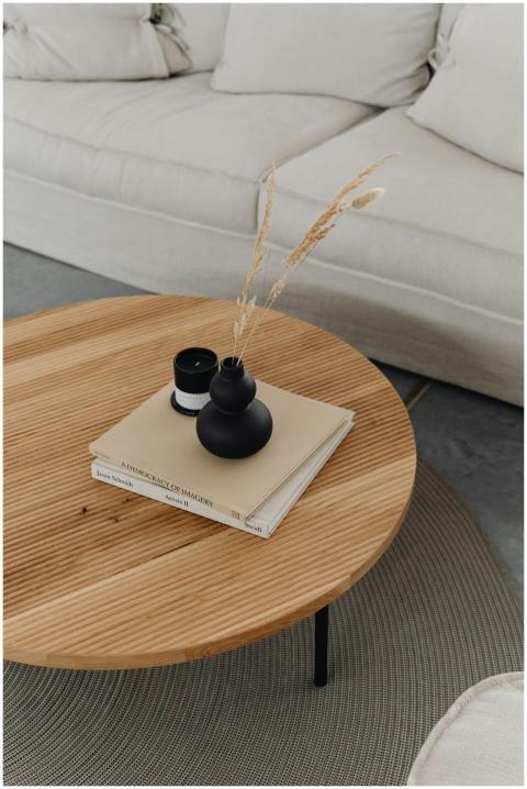 A minimalist coffee table with books and a black v