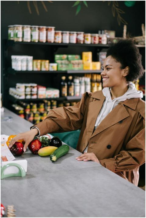Woman with afro hair in a brown coat selecting fre