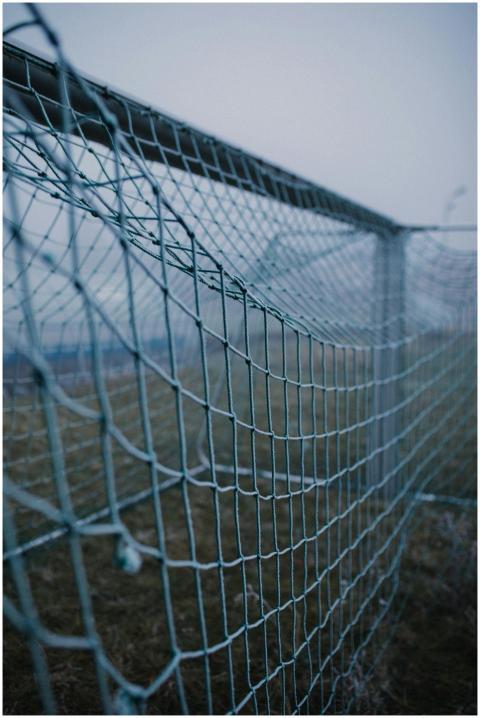 Detailed close-up of an empty football goal net un