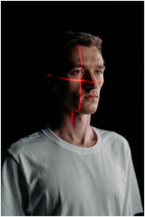 Studio portrait of expressionless man with red las