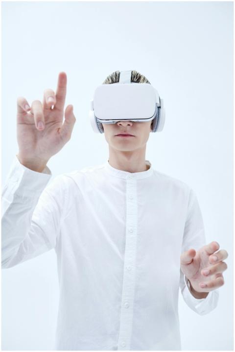 Person using VR headset with futuristic white back