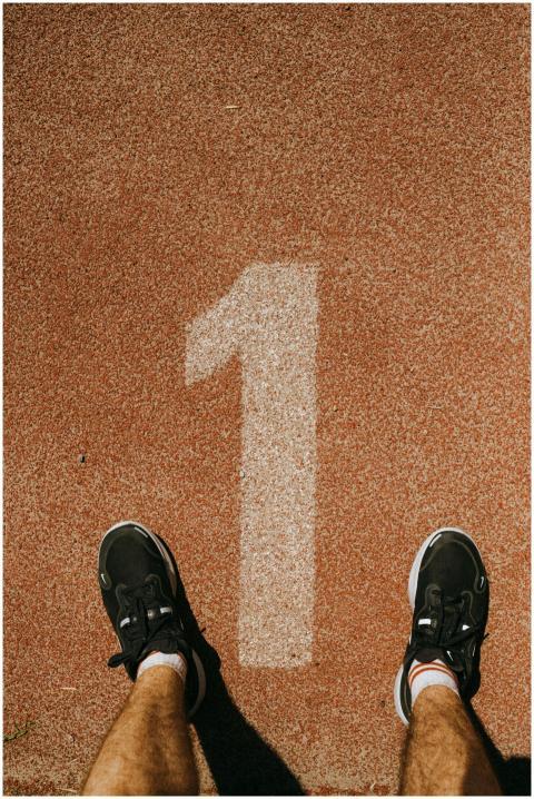 Runner ready at the starting line on a red race tr