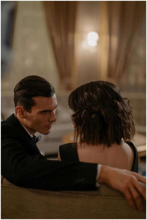 A couple sitting in a luxurious, elegant environme