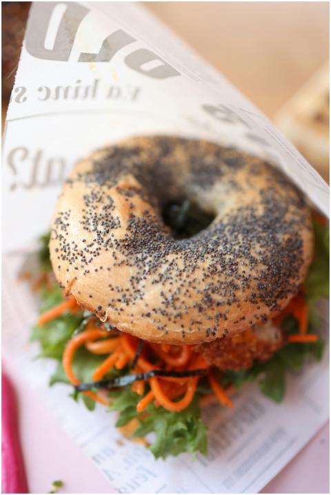 Tasty bagel sandwich with poppy seeds, carrots, an