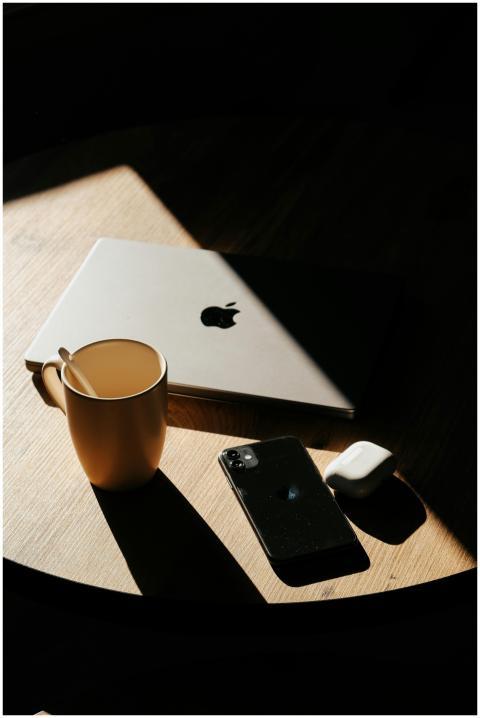 Wooden table with laptop, smartphone, and mug, hig