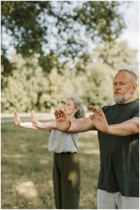Elderly couple meditating and enjoying wellness ou
