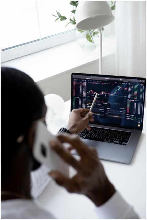 A businessman using a smartphone while analyzing s