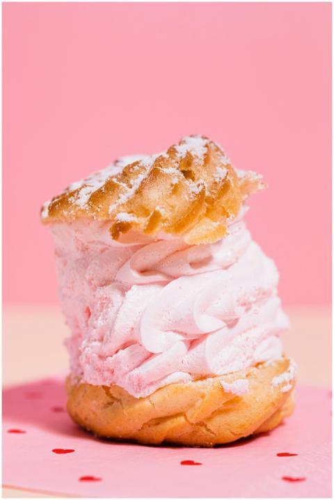 Close-up of a cream puff dessert with pink frostin