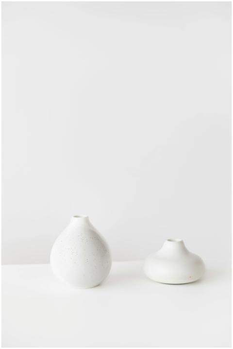 Elegant minimalist white ceramic vases on a blank