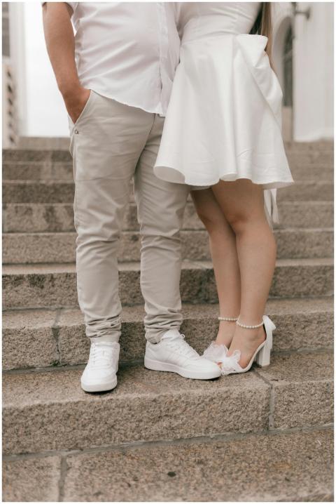 Romantic couple standing on stone steps in elegant