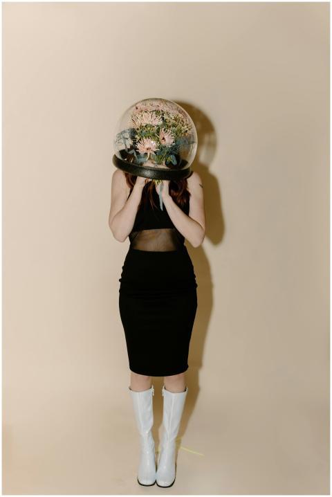 A stylish woman in futuristic attire with a transp