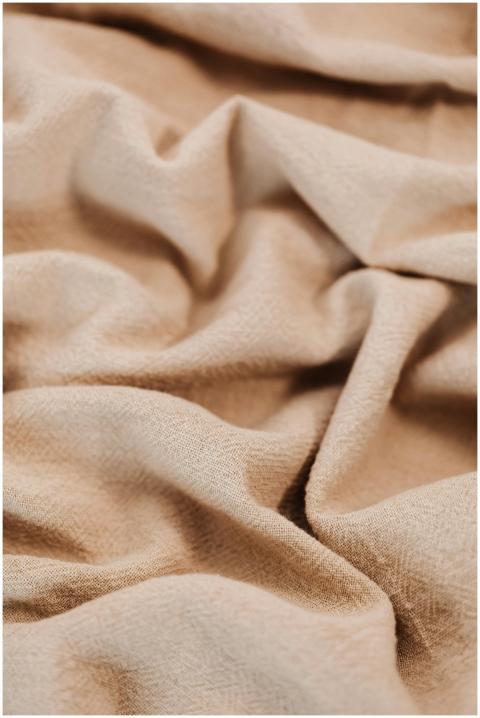 A close-up shot of textured beige fabric with natu