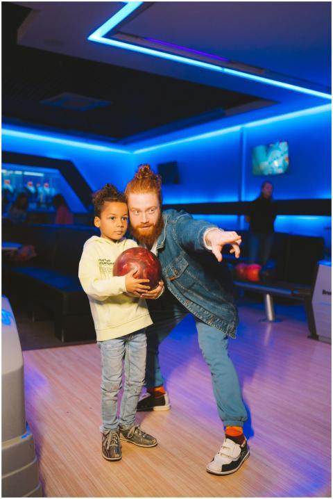Father and son enjoying a day at the bowling alley