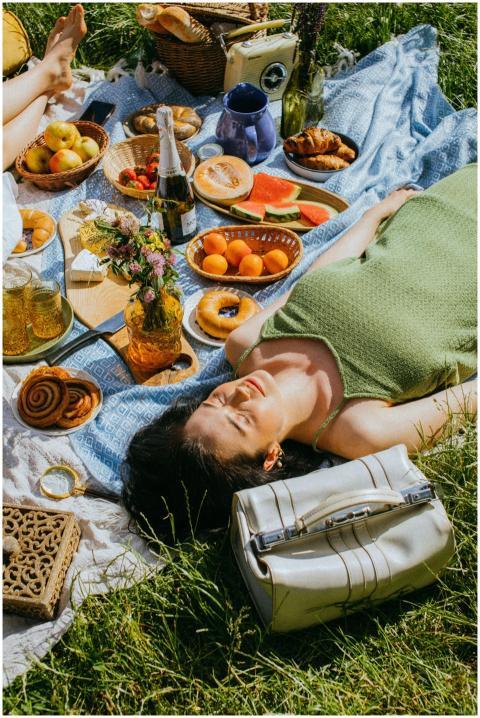 Enjoy a sunlit picnic with fresh fruits, pastries,