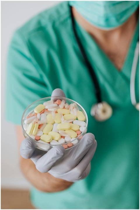 Healthcare worker in green scrubs holding a dish o