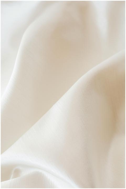 Close-up view of luxurious white fabric with a sat