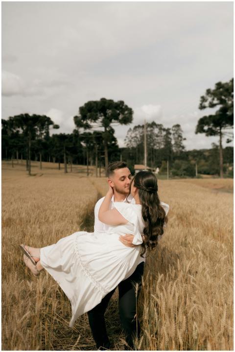 Couple in love embracing in a golden wheat field,