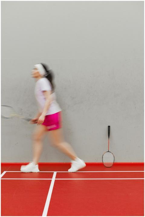 Blurry motion capture of a woman playing badminton
