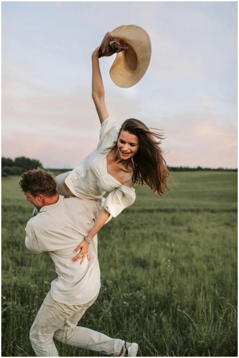 Happy couple enjoying a playful moment in a green