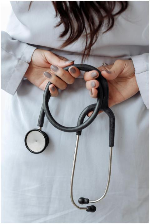 Close-up shot of a doctor holding a stethoscope wi